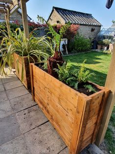 a wooden planter filled with lots of plants