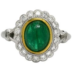 A classic Princess Diana style gemstone engagement ring. Centered by a glowing near 2 carat oval emerald with a lush, vibrant medium-dark green, complimented by a yellow gold bezel. The scalloped and milgrained 1/2 carat diamond halo adds a sparkling, fiery compliment to the rich gem. Eminently wearable with a low rise over your finger, it also has a commanding presence with a good amount of finger coverage. This would make an awesome right hand cocktail or statement ring as well.   Condition: N Reasonable Engagement Rings, Rose Gold Stackable Rings, Emerald Diamond Engagement Ring, Morganite Engagement Ring Rose Gold, Emerald Ring Engagement Diamond, Halo 2, Tanzanite Engagement Ring, Stackable Diamond Rings, Contemporary Engagement Rings