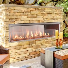 an outdoor patio with furniture and a fire place