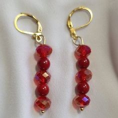 Two Red Coral Gemstone Beads and Three Red Faceted Glass Beads with Gold Tone Lever Backs. Red Dangle Jewelry With Faceted Beads, Red Beaded Crystal Drop Earrings, Red Handmade Dangle Crystal Earrings, Red Beaded Drop Crystal Earrings, Handmade Red Crystal Dangle Earrings, Red Handmade Crystal Dangle Earrings, Elegant Red Czech Glass Earrings, Handmade Red Czech Glass Beaded Earrings, Red Czech Glass Beaded Earrings With Dangling Beads