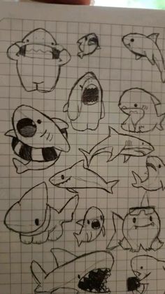 a drawing of different types of fish on a piece of paper with graph paper in front of it