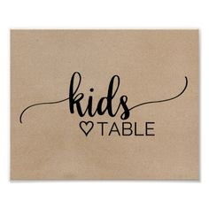 a piece of cardboard with the words kids table written on it and a heart in black ink