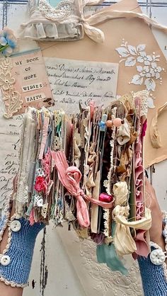 a woman's hands holding up an assortment of bracelets and brooches