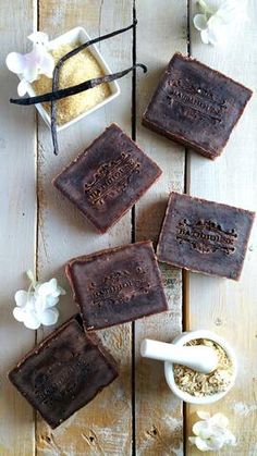 four brown soap bars sitting on top of a wooden table