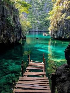 a wooden walkway leads to the blue lagoons in plitula national park, philippines