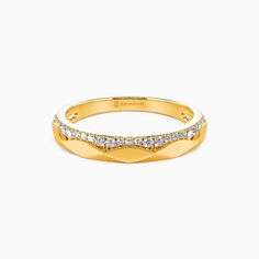 a yellow gold ring with diamonds on the sides and a curved band in the middle