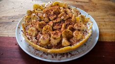 a white plate topped with food on top of a wooden table