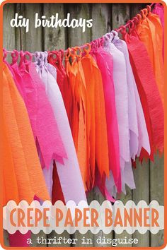 a banner with orange and pink streamers hanging from it