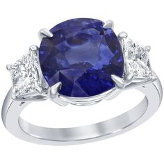 A unique engagement ring, featuring a GIA certified 6.15 carats round cushion cut blue Sri Lankan sapphire, set on a classic four prong basket setting. Flanked by two trapezoid shape diamonds weighing 1.18 carats total. Set on platinum mounting. Size 6 US, resizable upon request. Roman Malakov is a custom house, specializing in creating anything you can imagine. If you would like to receive a special quote on a custom piece, please message or call us. Cushion Cut Sapphire Ring, Contemporary Engagement Rings, Platinum Diamond Engagement Rings, Basket Setting, Modern Engagement Rings, Unique Engagement Ring, Round Cushion, Three Stone Diamond, Blue Sapphire Diamond