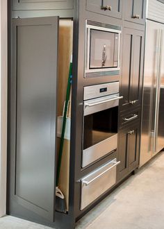 an oven built into the side of a cabinet in a kitchen with stainless steel appliances