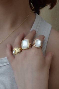 18k yellow gold with 60 round diamonds, 0.26Tw, and one mother of pearl with clear quartz on top, 11.64Tw. Size 6.5. Can be sized. Diamond White Stackable Ring Jewelry, Timeless White Jewelry With Vs Clarity, Elegant White Gemstone Signet Ring, Timeless White Diamond Open Ring, Timeless White Stackable Jewelry, Luxury Gemstone Open Ring Jewelry, Luxury White Crystal Ring With Round Cut, Luxury White Cubic Zirconia Stackable Rings, 14k Gold Rings With Plating