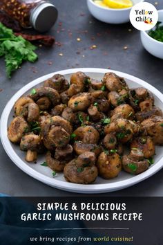 a white plate topped with mushrooms and garnished with parsley next to other dishes