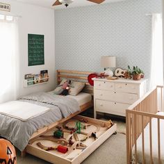 an instagramted photo of a child's bedroom with toys on the bed