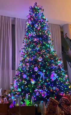 a brightly lit christmas tree in a living room