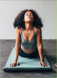 a woman is doing yoga on a mat