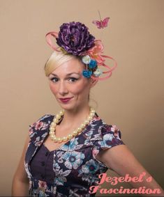 Butterfly Kisses - Floral fascinator in the most cheerful spring-time colors! Bursting in this blooming garden is a focal large bright pink rose, as a large purple floral stem peaks over your head with many other pink and purple summer flowers nestled throughout, as orange and powder blue butterflies flutter across the arrangement as flora and fauna dance together to create this fun yet classy headpiece! Spring Flower-shaped Fitted Fascinator, Spring Garden Party Fascinator With Handmade Flowers, Purple Fascinator With Handmade Flowers For Spring, Purple Flower Fascinator For Spring, Purple Summer Fascinator With Handmade Flowers, Summer Purple Fascinator With Handmade Flowers, Purple Spring Fascinator With Handmade Flowers, Spring Fascinator With Handmade Flowers, Handmade Purple Flower Fascinator For Spring