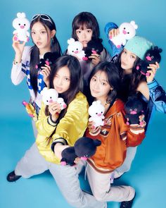 the girls are posing with stuffed animals in front of their faces and holding teddy bears