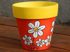 a flower pot sitting on top of a wooden table