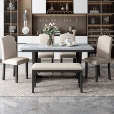 a dining room table with four chairs and a bench in front of the bookcase