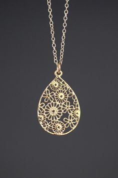 "A beautifully detailed bright 14k gold vermeil filigree teardrop flower charm simply dangles from a 14k gold filled chain. The chain is finished with a 14k gold filled lobster clasp. It is adjustable and can be worn close to the neck at 16\" or a little longer at 18\". This lightweight go-with-everything necklace completes any outfit for daytime or evening. Gold flower charm: 19x29mm Total length of pendant: 1 1/4\" Gold chain: 1.5mm Matching earrings are available... www.etsy.com/listing/52325 Gold Flower Jewelry With Intricate Design, Gold Filigree Teardrop Pendant Jewelry, Filigree Drop Jewelry As Gift, Filigree Drop Jewelry For Gifts, Gold Hypoallergenic Flower Pendant Jewelry, Gold Drop Jewelry With Intricate Design, Gold Intricate Drop Jewelry, Hypoallergenic Gold Flower Pendant Jewelry, Gold Teardrop Drop Necklace