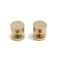 two golden knobs on a white background