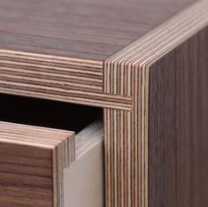 a close up view of the drawers on a wooden table with wood grained edges