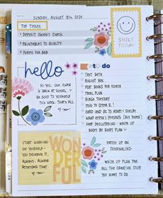 an open planner with flowers and words on it