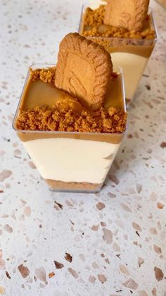 two desserts in small containers on a table