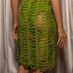 a mannequin wearing a green crochet dress