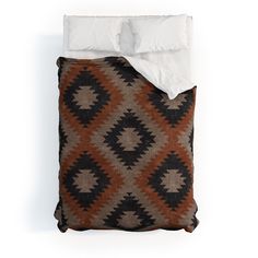 an image of a bed that is made with brown and white blankets on it's sides