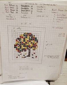 a cross - stitch tree is displayed on a piece of paper