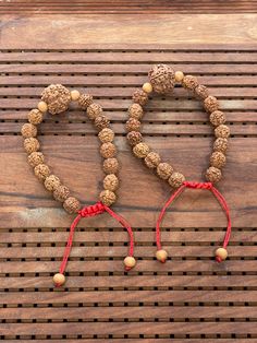 This is a divine pack of 2 Rudraksha bracelet made with 8 mm Rudraksha beads and 2 sandalwood beads.  This bracelet is adjustable so can fit any wrist size.  This is a healing Shiva bracelet, blessed by priest.  We wish you happy wearing and chanting Spiritual Wooden Beads Bracelets For Festivals, Traditional 8mm Beads Bracelets For Meditation, Traditional 8mm Bead Bracelets For Meditation, Adjustable Holistic Bracelets For Rituals, Brown Beaded Bracelets For Meditation And Festivals, Adjustable Holistic Beaded Bracelets For Rituals, Hand-strung Bracelets For Puja And Festivals, Brown Bracelets For Meditation And Festivals, Rudraksha Bracelet