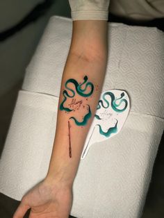 a person's arm with a tattoo on it and an arrow in the middle