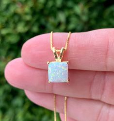 "Square Opal Halo Necklace in Gold over Sterling Silver - Minimalist Design in Square Shaped Cut - Gold over 925 Sterling Silver Setting - Gold over 925 Sterling Silver Box Chain - 16\", 18\", 20\", 22\" Chain Length - 13mm length, 7mm width - Lab Created Opal Center Stone - Prong Setting - Comes in Gift Box with Bow 🎁Packaging: This item comes gently packaged in a fabric pouch housed inside of a silver foil linen box with a silver bow. It is ready to present as a gift to someone special or to Elegant Jewelry With Polished Square Pendant, Fine Jewelry White Square Pendant Necklace, Square Pendant Gemstone Necklace For Gift, Elegant Square Gemstone Pendant Necklace, White Gold Square Pendant With Gemstone, Opal Necklace Gold, Polish Clothing, Opal Pendant Necklace, Silver Bow