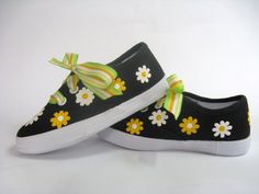 PLEASE SEE OUR SIZE CHART TO SELECT YOUR SIZE. SHOES TEND TO RUN SMALL. These cute daisy shoes have a striking design. We hand painted beautiful yellow and white flowers on our black canvas sneakers. We have added a bright yellow ribbon for the laces. Ribbons may vary according to availability. Perfect for summer time fun. PLEASE use our size chart below when selecting your size as some think they tend to run small. Some think the shoes are not sized like national brands. Measurements are taken Cute Summer Canvas Shoes With Rubber Sole, Cute Spring Canvas Shoes With Rubber Sole, Cute Canvas Shoes With Rubber Sole For Spring, Cute Yellow Sneakers For Spring, Yellow Lace-up Canvas Shoes For Spring, Yellow Canvas Sneakers For Spring, Yellow Slip-on Canvas Shoes For Spring, Fun Yellow Sneakers For Spring, Spring Yellow Canvas Shoes With Rubber Sole