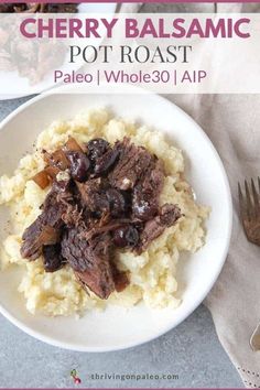 a white plate topped with mashed potatoes and beef