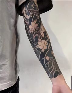 a man with a flower tattoo on his arm