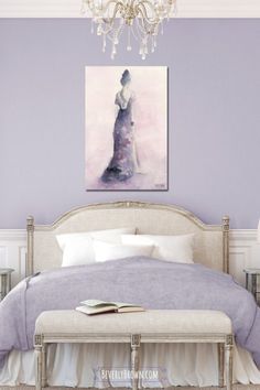 a bedroom with purple walls and a white bed in the center, along with a chandelier