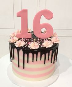 a birthday cake with pink and black icing that says'16'on top