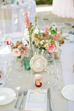 the table is set with flowers and silverware for an elegant wedding breakfast or reception