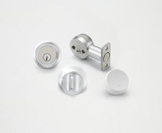 three different types of door knobs on a white surface