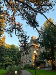 an old building is surrounded by trees and grass