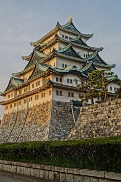 a tall building sitting on top of a stone wall