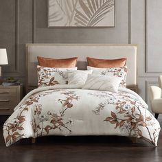 a bed with white and brown comforters in a room