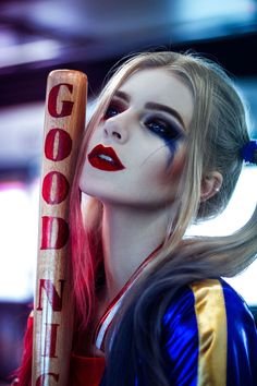 a woman with makeup holding a baseball bat