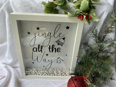 a christmas ornament with the words jungle at the way on it next to a potted plant