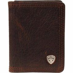 The Ariat Leather Bi-Fold Flip-Case Wallet with Concho features a distressed leather and Ariat brand concho. This simple bi-fold leather wallet features 7 card slots, 1 cash slot, and 6 picture slots on the inside. This Ariat flip-case wallet features a concho for added style. Inside features a clear ID slot Leather bi-fold wallet features 7 card slots, 1 cash slot, and 6 picture slots on the inside Ariat flip-case wallet with concho for added style Rugged Leather Bifold Wallet, Rugged Brown Bifold Wallet, Brown Bifold Wallet With Leather Patch, Rustic Brown Wallets With Card Slots, Rustic Brown Bifold Wallet, Western Style Brown Trifold Wallet With Card Slots, Western Leather Wallets With Card Slots, Western Leather Wallet With Card Slots, Western Style Brown Leather Wallet