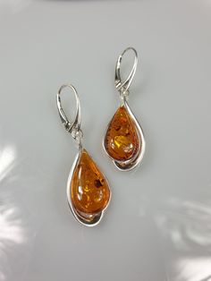 Welcome to my handmade shop. Item description: Sterling silver 925 earrings with Amber and all hallmarks. Length: 5 cm This item was made of natural Baltic Amber. All the amber used in my jewelry is collected in my home country Lithuania. I sell only genuine, real, not pressed, authentic, natural Baltic Amber. Item may have natural imperfections. Due to amber being natural, each of my jewelry is unique and even the same models can be slightly different. Please contact me for more details, photos