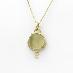 This lovely golden moonstone amulet is SASA's trademarked Art Deco style in a handmade 14K yellow gold setting. Little solid 'bubbles' of gold on the tip add sparkle when light falls upon them. According to Hindu mythology, moonstone is made of solidified moonbeams. Many other cultures also associate this gem with moonlight, and it's easy to see why. Its internal structure scatters the light that strikes it, creating a phenomenon known as adularescence. The visual effect is reminiscent of the fu Antique Yellow Gold Necklace With Cabochon, Yellow Gold Medallion Necklace With Cabochon, Gold Moonstone Round Jewelry, Yellow Gold Round Cabochon Necklace, Yellow Gold Amulet Jewelry With Cabochon, Yellow Gold Cabochon Amulet Jewelry, Gold Polished Moonstone Jewelry, Gold Moonstone Jewelry With Polished Finish, Spiritual Yellow Gold Cabochon Jewelry