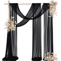 a black and white wedding arch decorated with flowers